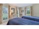 Bright bedroom with two twin beds, a dresser and windows with decorative curtains at 2300 N Scenic Hwy # 89, Lake Wales, FL 33898