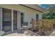 Inviting patio area with a comfortable chair, sliding glass doors and garden of red roses at 2300 N Scenic Hwy # 89, Lake Wales, FL 33898