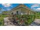 Charming home exterior surrounded by lush greenery and vibrant red roses along the walkway at 2300 N Scenic Hwy # 89, Lake Wales, FL 33898