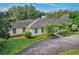 Well-maintained home with a beautiful paved driveway, mature trees, and a well manicured lawn at 2300 N Scenic Hwy # 89, Lake Wales, FL 33898