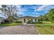 Charming guest house with an inviting exterior, beautiful landscaping, and a paved driveway at 2300 N Scenic Hwy # 89, Lake Wales, FL 33898