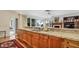Spacious kitchen featuring wood cabinets, granite countertops, and modern appliances at 2300 N Scenic Hwy # 89, Lake Wales, FL 33898