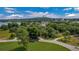 Expansive lot with lush trees, street view, and a lake view in the background at 2300 N Scenic Hwy # 61, Lake Wales, FL 33898
