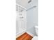 Bathroom featuring a walk-in shower with a glass door, white toilet, and wood floor at 2300 N Scenic Hwy # 61, Lake Wales, FL 33898