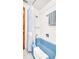 Bathroom features a blue bathtub with a white shower curtain and a wooden door at 2300 N Scenic Hwy # 61, Lake Wales, FL 33898