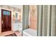 Bathroom with pink tile, a stylish shower curtain, and a dark wooden door at 2300 N Scenic Hwy # 61, Lake Wales, FL 33898