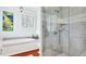 Modern bathroom featuring a glass-enclosed shower, soaking tub, and stylish finishes at 2300 N Scenic Hwy # 61, Lake Wales, FL 33898