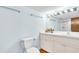 Bathroom featuring a long mirror, white vanity with storage, and toilet at 2300 N Scenic Hwy # 61, Lake Wales, FL 33898