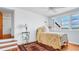 Cozy bedroom offers hardwood floors, a comfortable bed with a quilt, and ample natural light at 2300 N Scenic Hwy # 61, Lake Wales, FL 33898