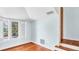 Simple bedroom with hardwood floors, light blue walls, large window and white trim at 2300 N Scenic Hwy # 61, Lake Wales, FL 33898
