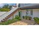 Charming courtyard featuring an exterior staircase leading to a balcony, lush landscaping and a brick patio at 2300 N Scenic Hwy # 61, Lake Wales, FL 33898