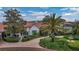 Elegant home with a red tile roof, paver driveway and lush landscaping including a three-tiered fountain at 2300 N Scenic Hwy # 61, Lake Wales, FL 33898