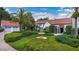 Stunning home exterior featuring a lush front yard, a fountain, and a two-car garage at 2300 N Scenic Hwy # 61, Lake Wales, FL 33898