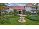 Charming home featuring a beautiful tiered fountain surrounded by well-manicured landscaping at 2300 N Scenic Hwy # 61, Lake Wales, FL 33898