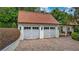 Two-car garage featuring paneled garage doors and overhead lanterns with a brick paver driveway at 2300 N Scenic Hwy # 61, Lake Wales, FL 33898
