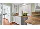 Charming kitchen features stainless steel dishwasher, granite countertops, and white cabinetry with ample natural light at 2300 N Scenic Hwy # 61, Lake Wales, FL 33898