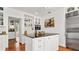 Well-equipped kitchen boasts a black center island, stainless steel appliances, and stylish white cabinetry at 2300 N Scenic Hwy # 61, Lake Wales, FL 33898