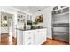 The kitchen has stainless steel appliances, a center island, white cabinets, and hardwood floors at 2300 N Scenic Hwy # 61, Lake Wales, FL 33898