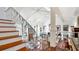 Open-concept floor plan with white interiors, hardwood floors, fireplace, and staircase at 2300 N Scenic Hwy # 61, Lake Wales, FL 33898