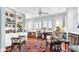 Well-lit living room with hardwood floors, built-in shelving, comfortable seating, and three large windows at 2300 N Scenic Hwy # 61, Lake Wales, FL 33898