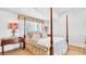 Bright main bedroom with white walls, a four-poster bed, and two side tables at 2300 N Scenic Hwy # 61, Lake Wales, FL 33898