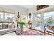A sitting area has a rug, hardwood floors, and natural light from the doors and windows at 2300 N Scenic Hwy # 61, Lake Wales, FL 33898