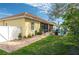 Well-maintained backyard with a brick patio, lush green lawn, and a charming white fence at 315 Bayberry Dr, Polk City, FL 33868