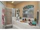 A beautifully tiled bathtub and shower with a stained-glass window at 315 Bayberry Dr, Polk City, FL 33868