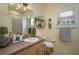 Bright bathroom featuring a single sink vanity, decor, and a window that allows natural light at 315 Bayberry Dr, Polk City, FL 33868