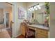 Elegant bathroom vanity area with well-lit mirror and floral decor at 315 Bayberry Dr, Polk City, FL 33868