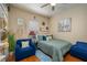 Comfortable bedroom with a cozy armchair, decorative wall art, and ample natural light at 315 Bayberry Dr, Polk City, FL 33868