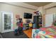 Bright bedroom featuring a dedicated workspace, modern furnishings, and a private entrance at 315 Bayberry Dr, Polk City, FL 33868