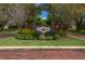 Well-maintained community entrance with brick signage, landscaping, and manicured green space at 315 Bayberry Dr, Polk City, FL 33868