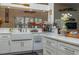 Bright kitchen with white cabinetry, modern appliances, a farmhouse sink, and views of the outdoor scenery at 315 Bayberry Dr, Polk City, FL 33868