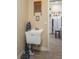 Bright laundry room boasts a utility sink and is conveniently located next to the kitchen at 315 Bayberry Dr, Polk City, FL 33868