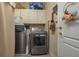 Functional laundry room with modern washer and dryer, plus overhead storage cabinets at 315 Bayberry Dr, Polk City, FL 33868