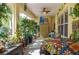 Bright sunroom with lots of plants and natural light, perfect for relaxation at 315 Bayberry Dr, Polk City, FL 33868