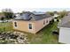 Wide view of the house with installed solar panels, and green lawns at 318 Gladesdale St, Haines City, FL 33844