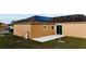 Backyard with solar panels and a concrete patio perfect for relaxation at 318 Gladesdale St, Haines City, FL 33844
