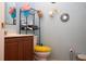 Compact bathroom featuring a toilet, sink, and mirror with blue colored walls at 318 Gladesdale St, Haines City, FL 33844