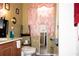 Functional bathroom with a vanity, toilet, mirror, and shelving unit at 318 Gladesdale St, Haines City, FL 33844