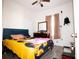 This bedroom features a ceiling fan, window, and dark wood floors at 318 Gladesdale St, Haines City, FL 33844