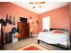 Cozy bedroom featuring tile floors, ceiling fan, and bright natural light from the window at 318 Gladesdale St, Haines City, FL 33844