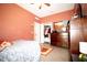 A primary bedroom boasts an ensuite closet with wood-look tile floors and warm paint at 318 Gladesdale St, Haines City, FL 33844
