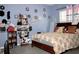 Cozy bedroom featuring a floral bedspread, decorative wall accents, and laminate wood floors at 318 Gladesdale St, Haines City, FL 33844