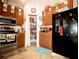 Open kitchen featuring stainless steel appliances, pantry, and adjacent cabinets at 318 Gladesdale St, Haines City, FL 33844