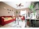 Relax in this living room with comfy furniture, ceiling fan, and decor at 318 Gladesdale St, Haines City, FL 33844