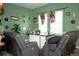 Inviting living room with green walls, sofa chairs, glass table, and decorative accents at 318 Gladesdale St, Haines City, FL 33844