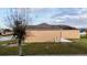 Sideyard view of the house featuring yard and clear sky above at 318 Gladesdale St, Haines City, FL 33844