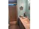 Bathroom featuring a shower and vanity with counter space and wall decorations at 32 Berna Cir, Winter Haven, FL 33884